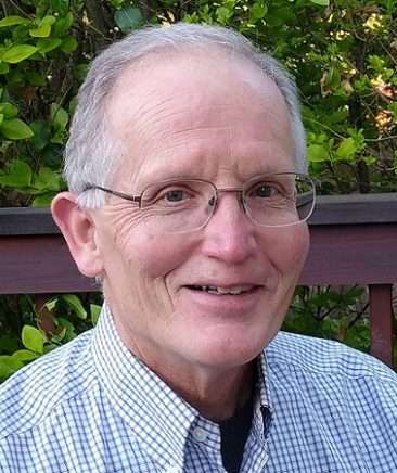 Robert Frank Robert Frank smiling in glasses and wearing a checkered shirt outdoors, representing the Vision Matters team and mission.