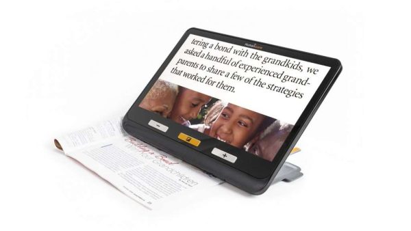Explorē 12 displaying text and a photo while magnifying a printed page underneath the screen.