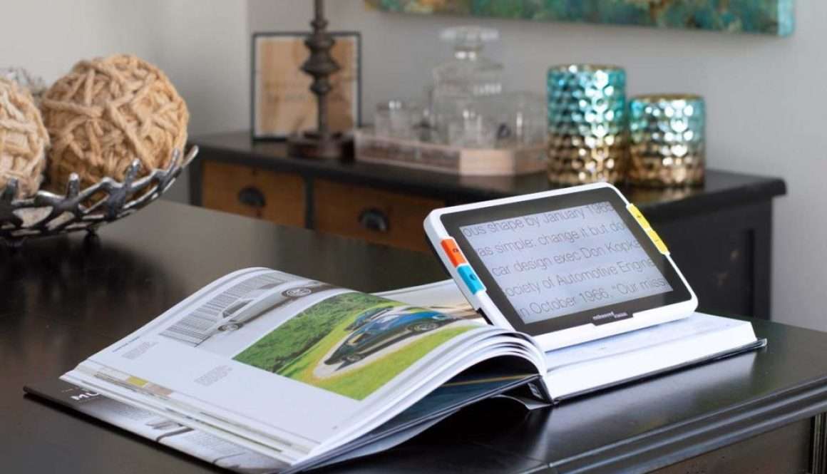 Amigo portable magnifier placed on an open book for easy reading at home
