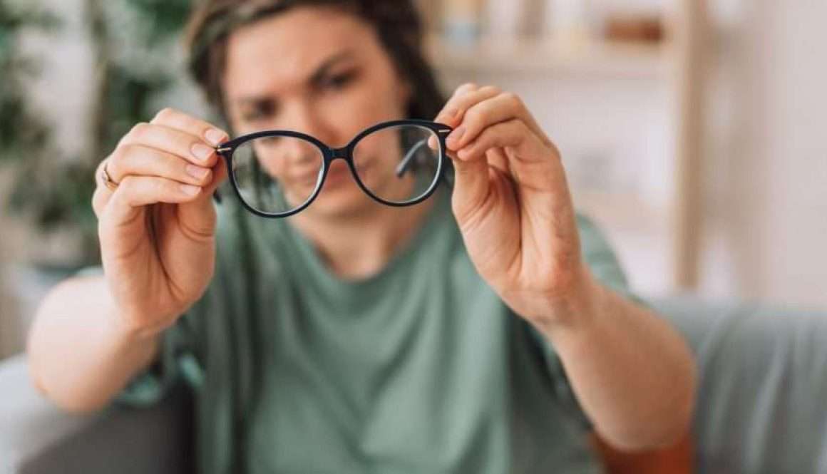 The girl looks at the glasses checking for dirt