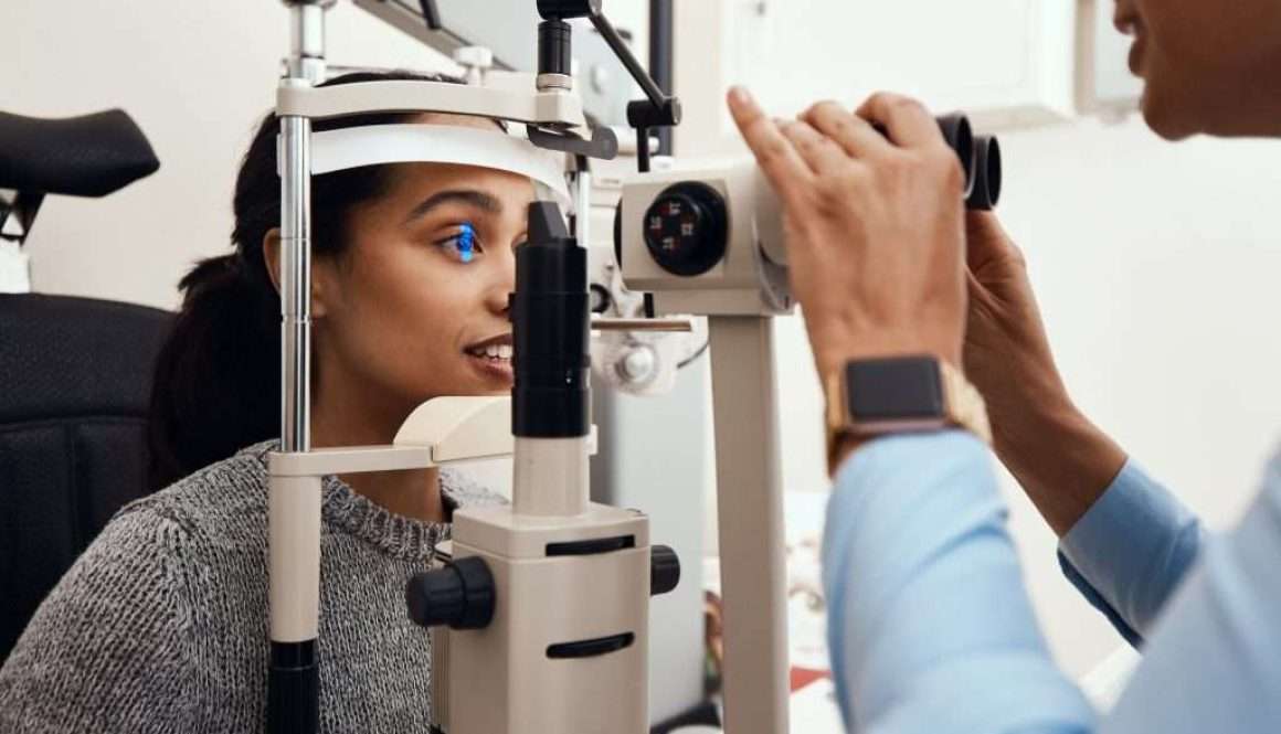 Eye test, exam or screening with an ophthalmoscope and an optometrist or optician in the optometry industry. Young woman getting her eyes tested for prescription glasses or contact lenses for vision